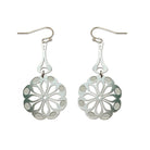 The Tribe earrings on white: silver steel flower medallions hanging from long drops.