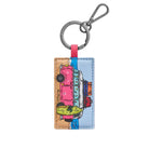 Camper keyring: a pink camper van with a green surfboard against sand and pale blue, on a gunmetal ring and clip.