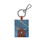 Highland Cow Blue/Tan keyring: a shaggy red-brown Highland cow with pale horns on a blue woven tweed front, on a gunmetal ring and clip.