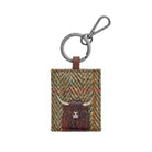 Highland Cow Green/Brown keyring: a shaggy dark brown Highland cow with pale horns on a green and brown woven tweed front, on a gunmetal ring and clip.