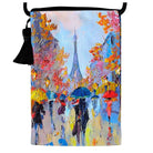 Velour shoulder pouch printed with a rainy Paris street of umbrellas below the Eiffel Tower, with a black cord strap and tassel.
