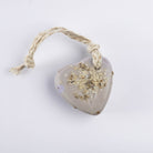 A pale lilac heart soap topped with lavender buds, with a jute loop
