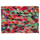 The Wildflower Carnival scarf laid flat with its fringed ends