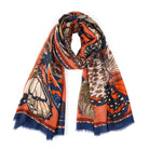 Scarf printed with large butterflies in orange, navy and cream, draped in a loop