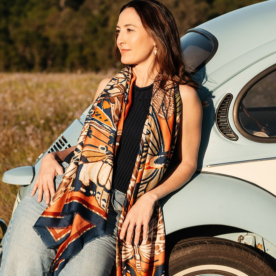 Wing scarf worn draped beside a vintage car