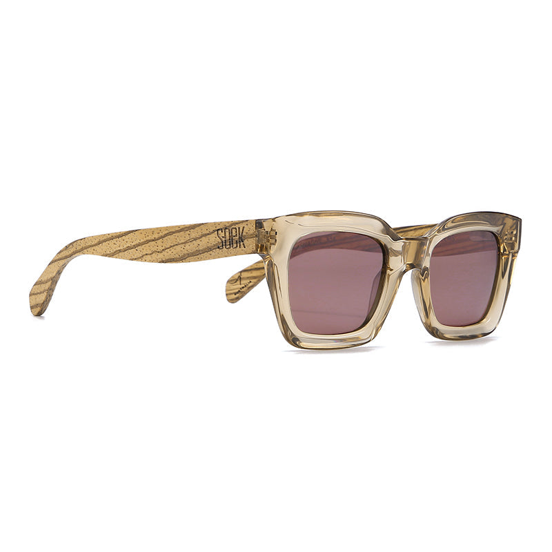 Zahra Champagne sunglasses at an angle, with Soek engraved on the striped walnut arm