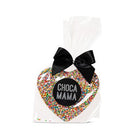 Milk chocolate heart covered in rainbow sprinkles in a clear cello bag with a black satin bow and a round black Chocamama label