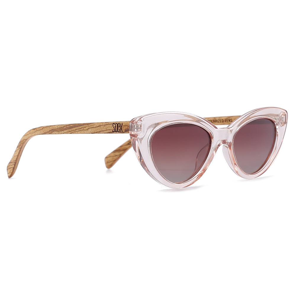 Savannah Blush Pink sunglasses at an angle: a clear pink cat-eye frame, brown gradient lenses and striped walnut arms