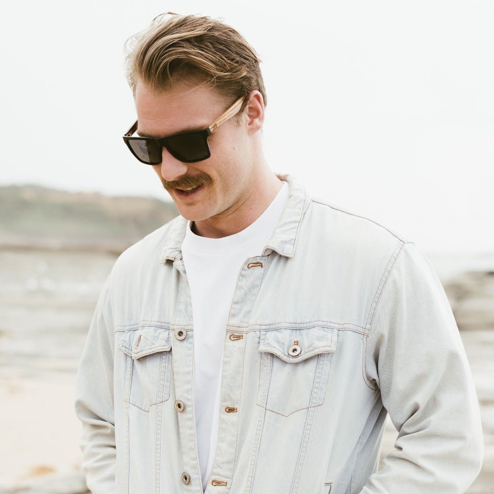 A man wearing the Dalton sunglasses, looking down and to the side