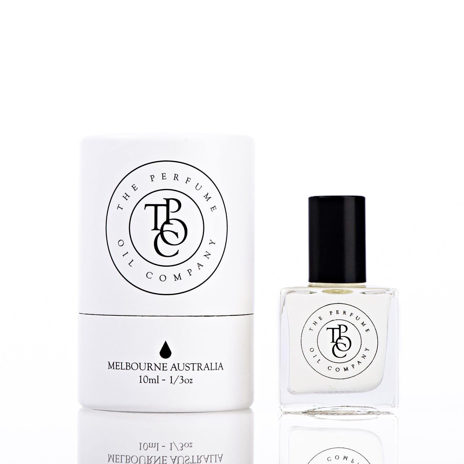 The Perfume Oil Company white gift cylinder beside a 10 ml bottle of perfume oil, front view