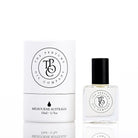 The Perfume Oil Company white gift cylinder beside a 10 ml bottle of perfume oil, black cap