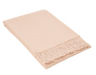 Blush pink merino wool blend throw folded neatly with a knotted fringe along one edge