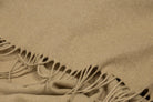 Close-up of the camel throw's fringe and soft flecked weave