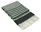 Black and cream striped reclaimed wool throw folded with a knotted fringe at the end