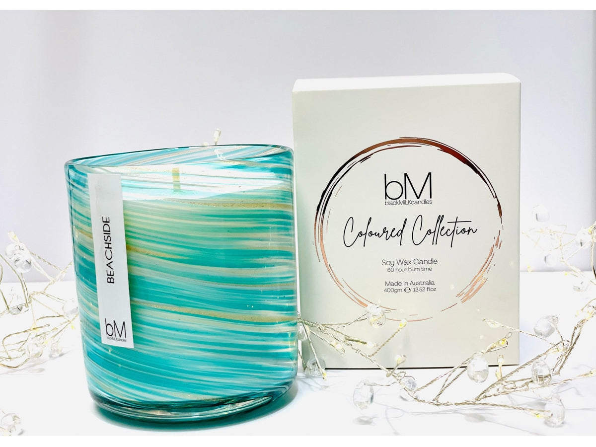 Vogue candle in swirled turquoise and white glass with a Beachside label, beside its white Coloured Collection gift box
