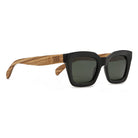 Zahra sunglasses in black at an angle, a square frame with pale zebrawood arms and khaki lenses